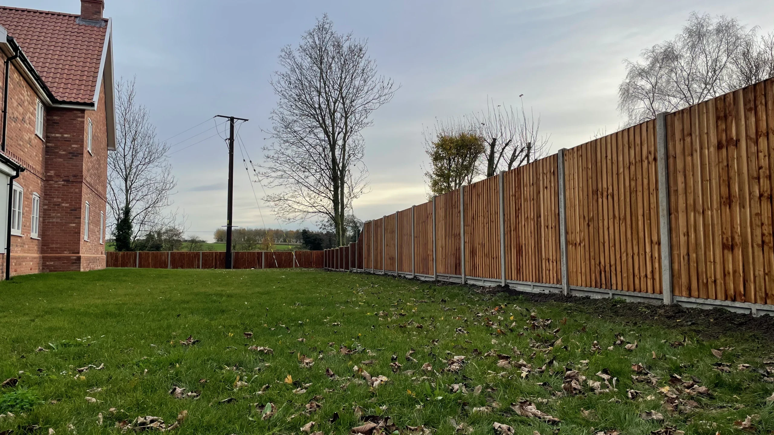 Professional closeboard garden fence installation with concrete posts